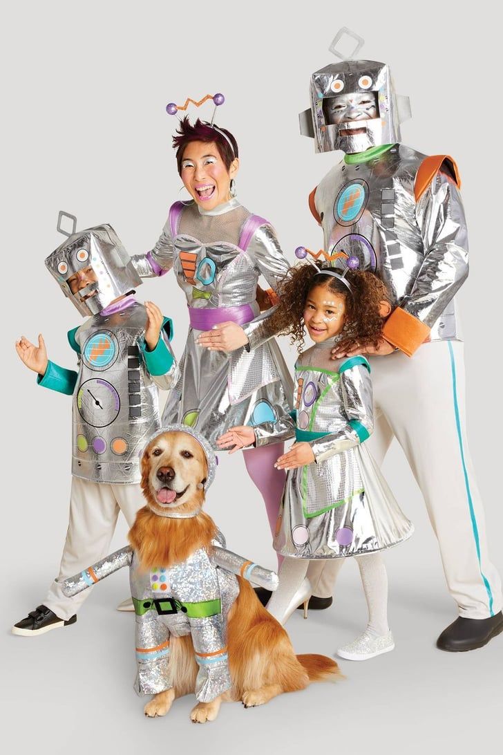 This may contain: a group of people in costumes standing next to a dog