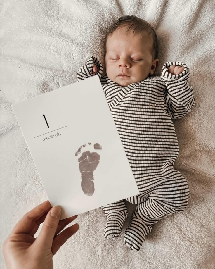 This may contain: a baby is being held up to a birth record